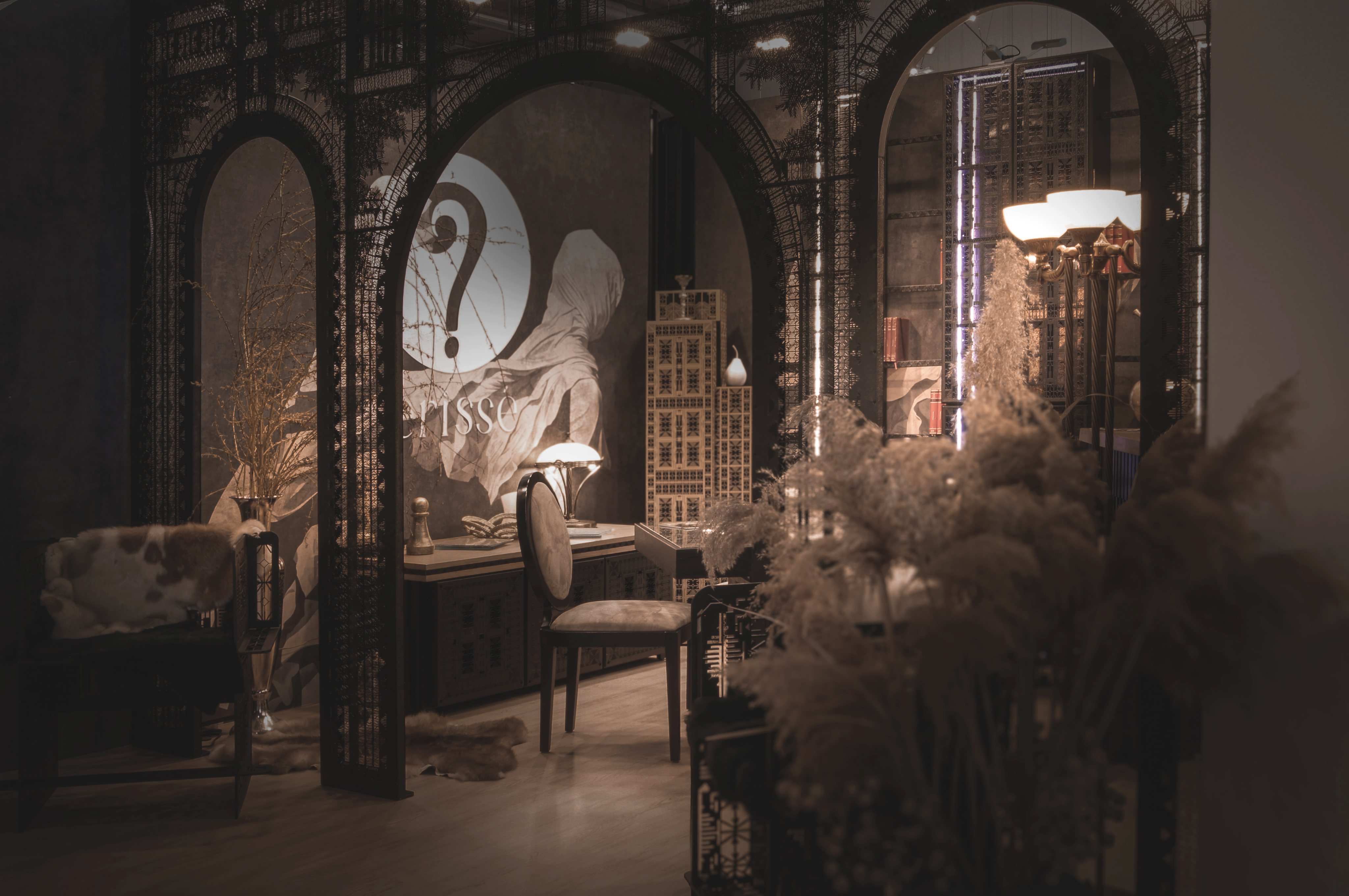 Dimly lit interior composition with arched decorative screens, warm lamps, and an intimate seating area.